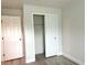 Neutral bedroom with closet, clean lines, and updated flooring at 6667 Blanton Ct, Orlando, FL 32809