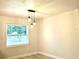 This bedroom features a modern light fixture, wood-look flooring, and a sunlit atmosphere at 6667 Blanton Ct, Orlando, FL 32809