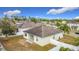 An aerial view of the home's backyard with a white fence and other houses in the neighborhood at 673 Highland Meadows Ave, Davenport, FL 33837