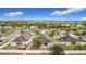 An aerial view shows the home's backyard, a white fence, and other homes within the community at 673 Highland Meadows Ave, Davenport, FL 33837