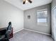 This bedroom has neutral colors, a large window to let in natural light, and a ceiling fan at 673 Highland Meadows Ave, Davenport, FL 33837