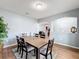 A dining room features a wood table and chairs atop an area rug with decor on the table at 673 Highland Meadows Ave, Davenport, FL 33837