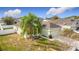 An eye-level side view of a single-story home with an attached two-car garage and a palm tree in the front yard at 673 Highland Meadows Ave, Davenport, FL 33837