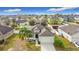 An aerial view of a charming single-story home with a well-maintained lawn and a two-car garage at 673 Highland Meadows Ave, Davenport, FL 33837