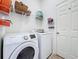 The laundry room features new Samsung washer and dryer, white wire shelving, and a door at 673 Highland Meadows Ave, Davenport, FL 33837