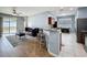 A living room and bar-style eating area adjacent to the kitchen features hardwood floors at 673 Highland Meadows Ave, Davenport, FL 33837