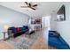 A living room features hardwood floors, a ceiling fan, a sofa, and a coffee table at 673 Highland Meadows Ave, Davenport, FL 33837