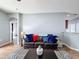 A living room features hardwood floors, a ceiling fan, a sofa, and a coffee table at 673 Highland Meadows Ave, Davenport, FL 33837