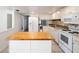 Updated kitchen featuring white appliances and a functional butcher block island at 710 Saint Matthew Cir # 710, Altamonte Springs, FL 32714