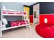 Fun bunk bed room with playful Mickey Mouse themed decor and an ensuite bathroom view at 7463 Marker Ave, Kissimmee, FL 34747