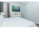 Bright bedroom with a white bed, dresser, closet and neutral decor at 7463 Marker Ave, Kissimmee, FL 34747