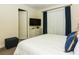 Bedroom featuring a white bedspread, TV, dresser, light-blocking curtains, and ensuite bathroom at 7463 Marker Ave, Kissimmee, FL 34747