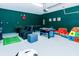 Large garage game room with air hockey, a foosball table, seating, and a play structure at 7463 Marker Ave, Kissimmee, FL 34747