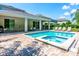 Beautiful backyard pool and spa area with a covered patio and outdoor dining space at 7463 Marker Ave, Kissimmee, FL 34747