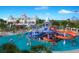 Aerial view of the water park featuring slides, pools, a resort building, and people having fun at 7463 Marker Ave, Kissimmee, FL 34747