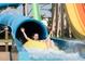 Person enjoying a thrilling ride down a vibrant blue water slide with splashy water at 7463 Marker Ave, Kissimmee, FL 34747