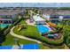 Aerial view of a community park featuring a playground, splash pad, and well-manicured lawns at 7479 Marker Ave, Kissimmee, FL 34747