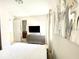 Bright bedroom featuring a grey dresser and a wall-mounted TV at 7479 Marker Ave, Kissimmee, FL 34747