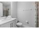 Modern bathroom with white vanity, large mirror, and tile shower at 7483 Marker Ave, Kissimmee, FL 34747