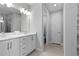 Bright bathroom featuring a double vanity and a tiled shower at 7483 Marker Ave, Kissimmee, FL 34747