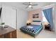 Cozy bedroom featuring a blue patterned bedspread, wood furniture, and soft pink walls at 7483 Marker Ave, Kissimmee, FL 34747