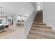 Light and bright entryway featuring stairs with carpet runner, with a view of the kitchen and living area at 7483 Marker Ave, Kissimmee, FL 34747