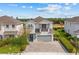 Two-story home with a two car garage and balcony with a well-manicured lawn at 7483 Marker Ave, Kissimmee, FL 34747