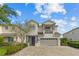 Charming two-story home with a two car garage and balcony, complemented by a brick driveway at 7483 Marker Ave, Kissimmee, FL 34747