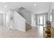 Light-filled foyer with staircase, tile flooring, and stylish decor at 7483 Marker Ave, Kissimmee, FL 34747