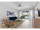 Cozy living room featuring a blue velvet sofa, stylish decor, and sliding glass doors leading to the pool area at 7483 Marker Ave, Kissimmee, FL 34747