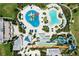 An aerial view of a waterpark with pools, waterslides, lounge areas, and meticulously landscaped grounds at 7483 Marker Ave, Kissimmee, FL 34747