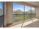 A screened-in balcony has tile flooring and a wrought-iron railing with views of the exterior landscape at 8312 Fontera Dr, Davenport, FL 33896