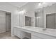 Bright bathroom featuring double sink vanity and walk-in shower at 8312 Fontera Dr, Davenport, FL 33896