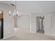 Elegant dining area showcasing a stylish chandelier, neutral walls, and open access to other living spaces at 8312 Fontera Dr, Davenport, FL 33896