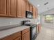 The well-lit kitchen offers wooden cabinets, streamlined countertops, and modern appliances, blending style and functionality at 8312 Fontera Dr, Davenport, FL 33896