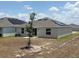 Home exterior featuring solar panels and a spacious backyard perfect for outdoor activities at 945 Laurel View Way, Groveland, FL 34736