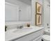 Clean bathroom with white cabinets, quartz countertops, and decorative wall art at 945 Laurel View Way, Groveland, FL 34736