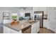 Modern kitchen featuring stainless steel appliances and a center island with a sink at 945 Laurel View Way, Groveland, FL 34736