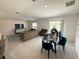 Bright, open living area with neutral tones, tile flooring, and ample natural light at 945 Laurel View Way, Groveland, FL 34736