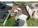 Aerial view of home with a brown roof, a two car garage, and mature landscaping at 1318 Horizon Creek Ct, Orlando, FL 32828