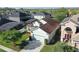 Aerial view of a well-manicured home with lush landscaping and a two car garage at 1318 Horizon Creek Ct, Orlando, FL 32828