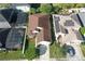 Overhead view of a house with brown roof, green lawn and mature trees in a sunny neighborhood at 1318 Horizon Creek Ct, Orlando, FL 32828