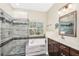 Bright bathroom features a glass shower, soaking tub, and vanity with great natural light at 1318 Horizon Creek Ct, Orlando, FL 32828