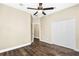 Bedroom with wood floors and ceiling fan with closet and doorway to other rooms at 1318 Horizon Creek Ct, Orlando, FL 32828