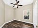 Bedroom with wood flooring, a ceiling fan, and a window with natural light at 1318 Horizon Creek Ct, Orlando, FL 32828