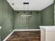 Stylish dining room with hardwood floors, contemporary lighting, and elegant green accent wall at 1318 Horizon Creek Ct, Orlando, FL 32828