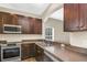 Well-equipped kitchen with stainless steel appliances, wood cabinets, and spacious countertops at 1318 Horizon Creek Ct, Orlando, FL 32828