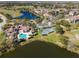 Aerial view of a residential community with pools, lakes, tennis courts, and lush landscaping at 13929 Fairway Island Dr # 825, Orlando, FL 32837