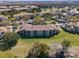 Aerial view of multi-Gathering condo buildings surrounded by a lake, landscaping, and plentiful parking at 13929 Fairway Island Dr # 825, Orlando, FL 32837