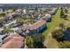 Aerial view of condos with terracotta tile roofs, featuring scenic lake views and lush green landscaping at 13929 Fairway Island Dr # 825, Orlando, FL 32837